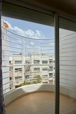 a view of a large building from a window at Appartement de luxe Résidence Du Palais GHANDI in Casablanca