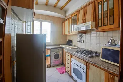 a kitchen with a refrigerator and a washing machine at Appartement de luxe Résidence Du Palais GHANDI in Casablanca