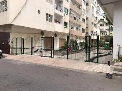 a black fence in front of a building at Appartement de luxe Résidence Du Palais GHANDI in Casablanca