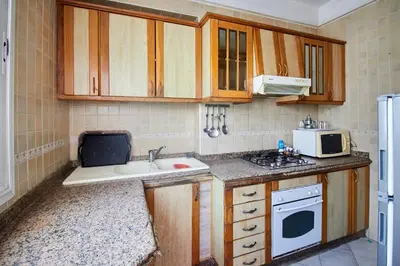 a small kitchen with a sink and a microwave at Appartement de luxe Résidence Du Palais GHANDI in Casablanca