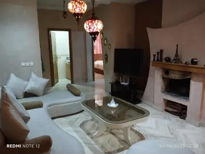 a living room with a couch and a fireplace at Appartement de luxe Résidence Du Palais GHANDI in Casablanca