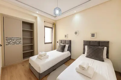 two beds sitting next to each other in a bedroom at Cosy ensoleillé 2CH proche de Mosquee hassan II et corniche in Casablanca