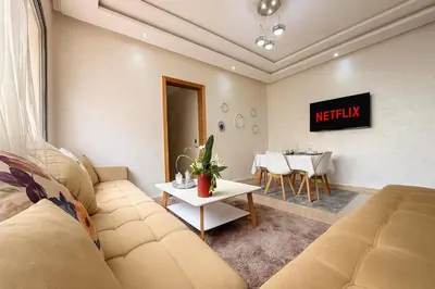 a living room with a couch and a table at Cosy ensoleillé 2CH proche de Mosquee hassan II et corniche in Casablanca