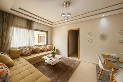 a living room with a couch and a table at Cosy ensoleillé 2CH proche de Mosquee hassan II et corniche in Casablanca