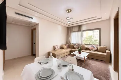 a living room with white tables and a couch at Cosy ensoleillé 2CH proche de Mosquee hassan II et corniche in Casablanca