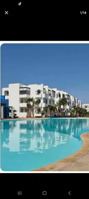 a large swimming pool in front of a building at Mansouria beach resort in Mohammedia