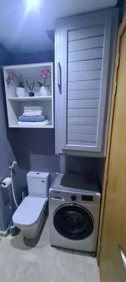 a bathroom with a washing machine and a toilet at Mansouria beach resort in Mohammedia