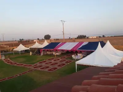 an overhead view of a group of tents in a field at Ferme