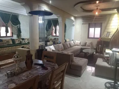 a living room with a couch and a table at Ferme