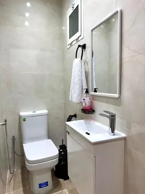 a bathroom with a white toilet and a sink at 2br near TGV station in Rabat