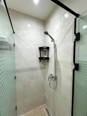a shower with a glass door in a bathroom at 2br near TGV station in Rabat