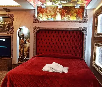 a bedroom with a red bed with two books on it at Appartements journaliers et mensuels in Aïn Chock