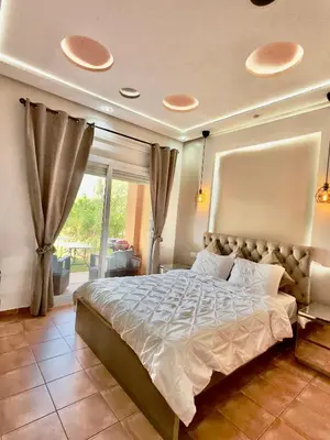 a bedroom with a large bed and a window at Appartement du luxe au cœur du Golf in Bouznika