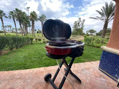 a grill sitting on top of a patio at Appartement du luxe au cœur du Golf in Bouznika