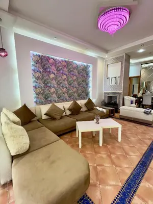a living room with a couch and a painting on the wall at Appartement du luxe au cœur du Golf in Bouznika