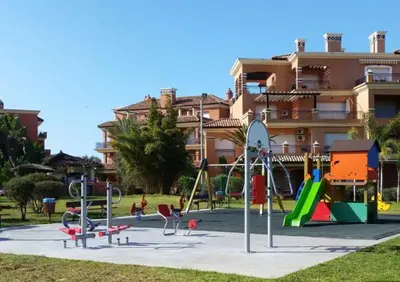 a playground in front of a large building at Appartement du luxe au cœur du Golf in Bouznika