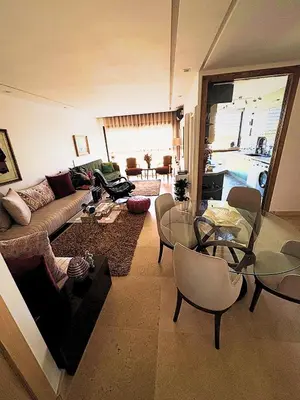 a living room with a couch and a table at Appartement moderne avec équipements de luxe in Maarif