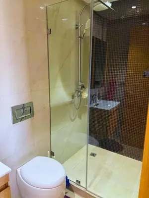a bathroom with a toilet and a glass shower at Appartement moderne avec équipements de luxe in Maarif