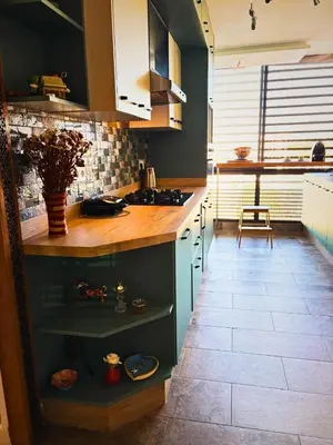 a kitchen with blue cabinets and a counter top at Appartement moderne avec équipements de luxe in Maarif