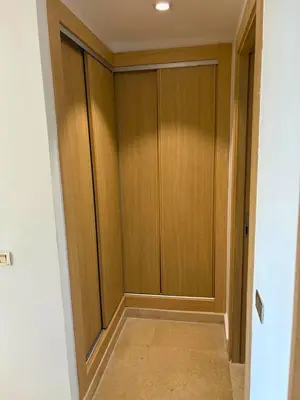 a hallway with wooden cabinets in a room at Appartement moderne avec équipements de luxe in Maarif