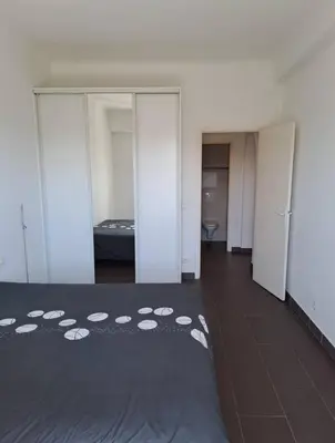 a room with a bed and a room with sliding doors at Chic and Calm Flat in Heart of Casa in Casablanca
