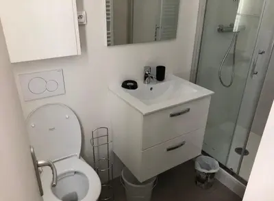 a bathroom with a toilet and a sink and a shower at Chic and Calm Flat in Heart of Casa in Casablanca