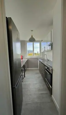 a kitchen with a stainless steel refrigerator and a window at Chic and Calm Flat in Heart of Casa in Casablanca