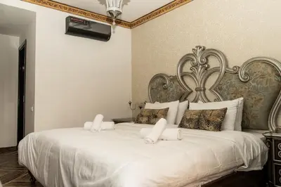 a bedroom with a large white bed with white pillows at Family apartment with balcony and Netflix in Temara