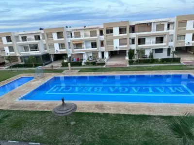 a swimming pool in front of an apartment building at Maison vacances Mansoria in Casablanca