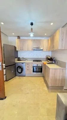 a kitchen with a stove and a refrigerator at Maison vacances Mansoria in Casablanca