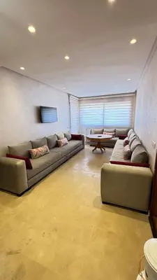 a living room with two couches and a table at Maison vacances Mansoria in Casablanca
