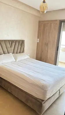 a bedroom with a large bed with a large white sheets at Maison vacances Mansoria in Casablanca
