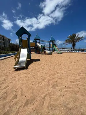 a group of playground equipment on the beach at Apartment with swimming pool in O Ben Slimane