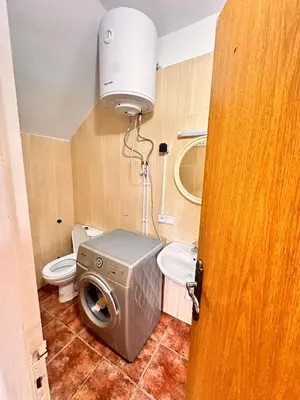 a bathroom with a washing machine and a toilet at Apartment with swimming pool in O Ben Slimane