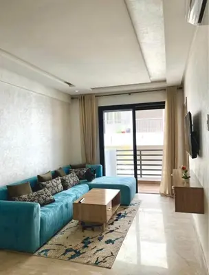 a living room with a blue couch and a table at Sunshine in Casablanca