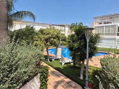 a house with a swimming pool and a street light at Résidence balnéaire Les perles de Tamaris in Tamaris