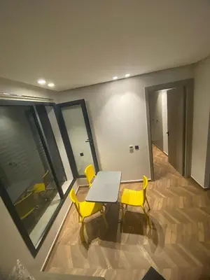 a dining room with a table and two yellow chairs at The Quiet House in Casablanca