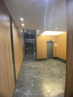 a hallway of a building with wooden walls and a marble floor at The Quiet House in Casablanca