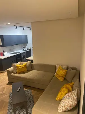 a living room with a couch and a kitchen at The Quiet House in Casablanca