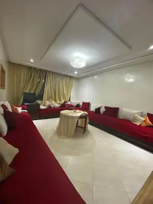 a living room with red couches and a table at The Bright House in Casablanca