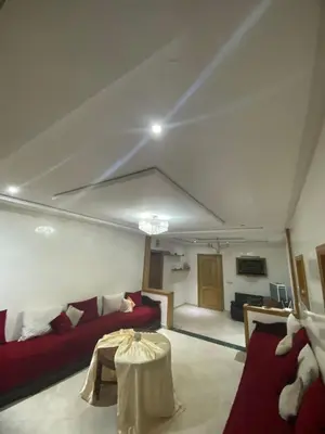 a living room with a red couch and a table at The Bright House in Casablanca
