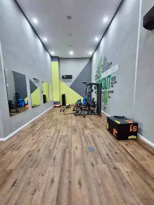 a room with a gym with a wooden floor at Natura Living Apartment in Mohammedia