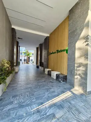 an empty hallway of a building with yellow walls at Natura Living Apartment in Mohammedia
