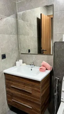 a bathroom with a sink and a mirror at Natura Living Apartment in Mohammedia