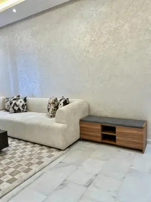 a living room with a couch and a table at Natura Living Apartment in Mohammedia