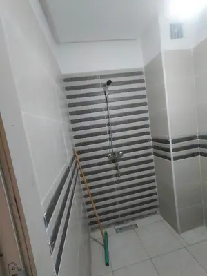 a bathroom with a shower in a room at Appartement calme et confortable in Bouznika