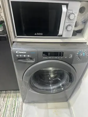 a microwave sitting on top of a washing machine at Studio bord de mer , La Siesta Beach Resort in Mohammedia