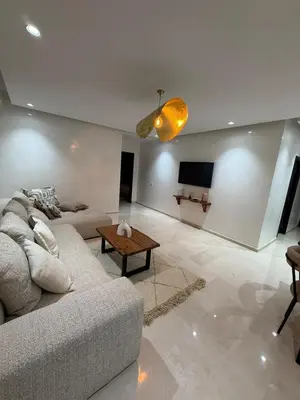 a living room with a couch and a tv at Elegant apartment Racine Bd AlMassira in Casablanca