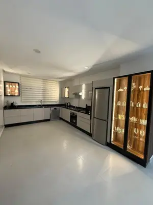 a large kitchen with white floors and a large room at Elegant apartment Racine Bd AlMassira in Casablanca