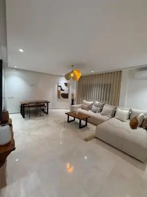 a living room with a couch and a table at Elegant apartment Racine Bd AlMassira in Casablanca